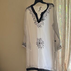 Embroidered White beach coverup with sequences throughout embroidery